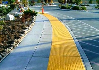 A yellow sidewalk with a yellow stripe in the middle.
