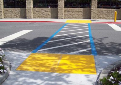 A sidewalk with a yellow stripe.