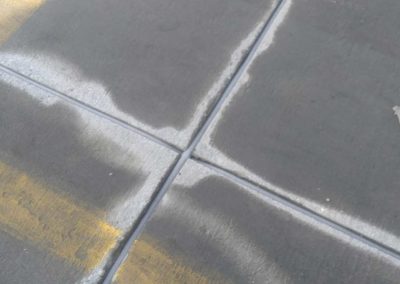 A close up of a concrete floor with a yellow line.