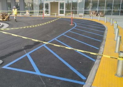 A parking lot with blue tape and yellow tape.