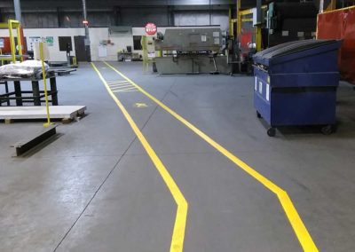 A yellow line on the floor of a factory.