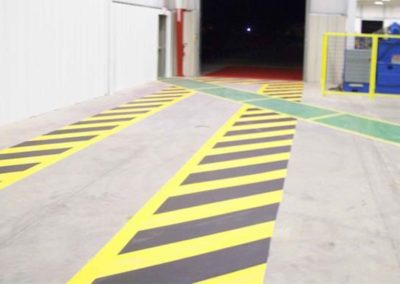 A yellow and black striped floor in a warehouse.
