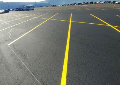 A parking lot with yellow lines on it.