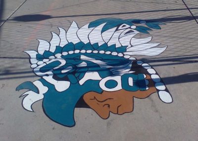 A painting of an indian head on the sidewalk.