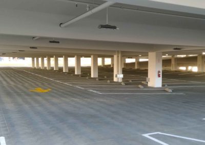 A parking garage with a lot of empty spaces.