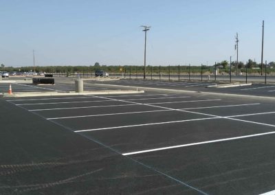 A parking lot with white lines on it.