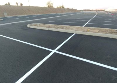 A parking lot with white lines painted on it.