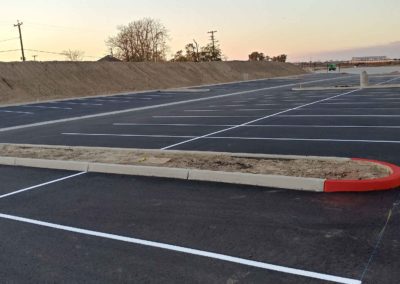 A parking lot with a white line and a red stripe.