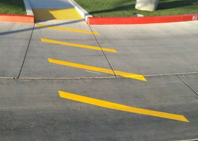A parking lot with a yellow stripe painted on it.