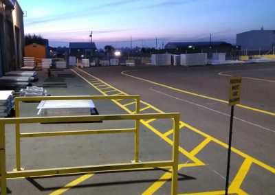 A parking lot at dusk with yellow markings.