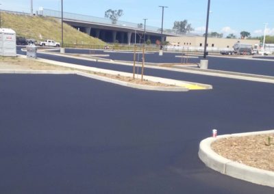 A parking lot with a black paved surface.