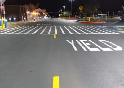 A parking lot with a yield sign painted on it.