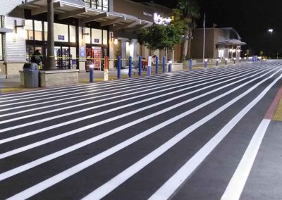 A stripe painted on a parking lot at night.